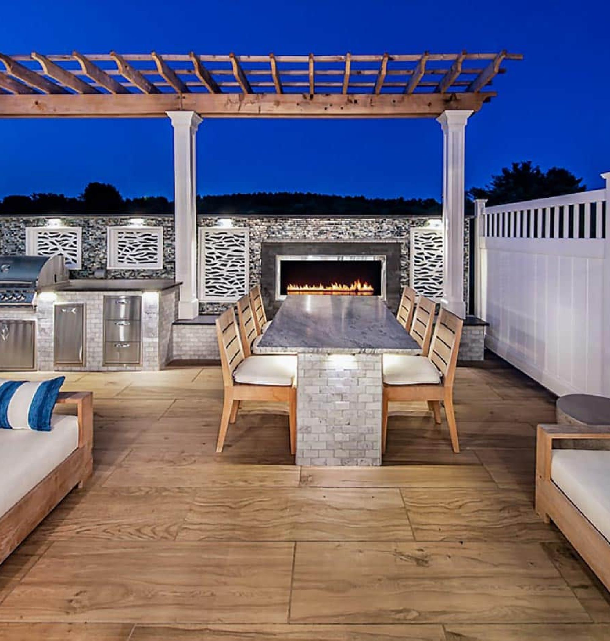 Custom Deck Elevated Outdoor Living Space | Wood deck with chairs, couch, grill, fence, and structure | Backyard Creations | Custom Decks, Porches, and Pergolas