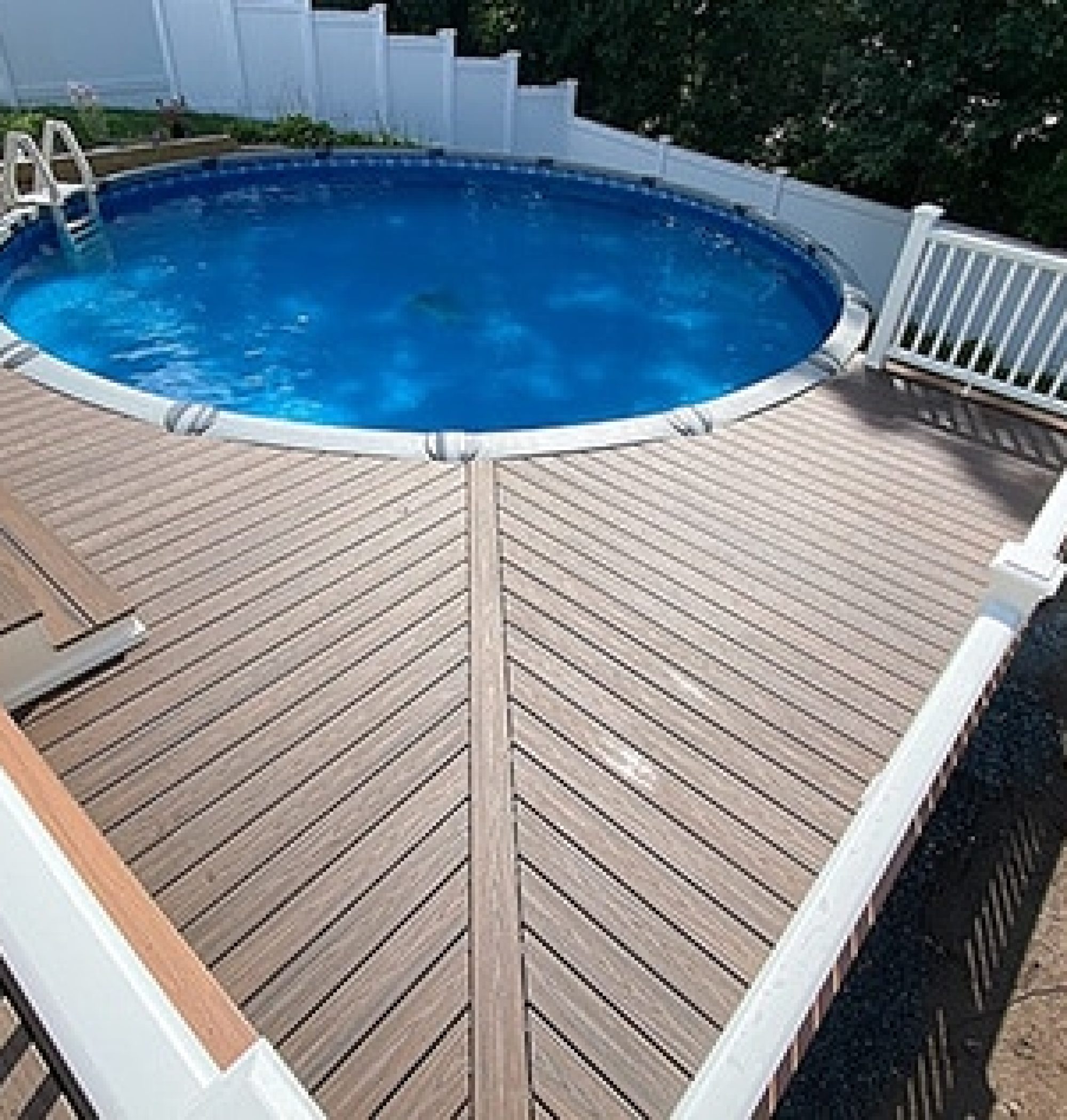 Custom Deck with pool | Pool with blue water with surrounding dark stained wood deck | Backyard Creations | Custom Decks, Porches, and Pergolas